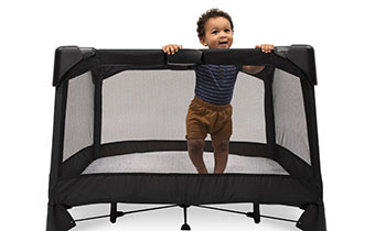 baby standing in Breeze Plus Playard