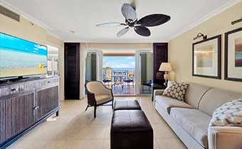 Suite living room with balcony overlooking ocean