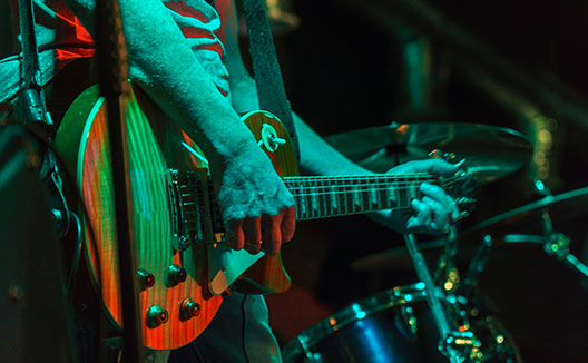 Close up of a person playing guitar